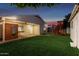 Spacious backyard featuring lush lawn, wooden play structure, and modern sauna perfect for Gathering enjoyment at 728 E State Ave, Phoenix, AZ 85020