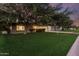Spacious front yard with lush green grass and mature trees, creating a serene and inviting curb appeal at 728 E State Ave, Phoenix, AZ 85020