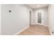 Spacious hallway with modern door and laminate flooring creating an inviting transition between rooms at 728 E State Ave, Phoenix, AZ 85020