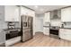 Well-equipped kitchen featuring stainless steel appliances, sleek countertops, and ample cabinetry for storage at 728 E State Ave, Phoenix, AZ 85020