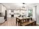 Modern kitchen with white cabinets, stainless steel appliances, and a center island complemented by a cozy dining area at 728 E State Ave, Phoenix, AZ 85020
