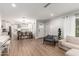 Open-concept living space featuring wood-style floors and seamless flow between living, dining, and kitchen areas at 728 E State Ave, Phoenix, AZ 85020