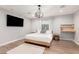 Bedroom with a king bed, wood floors, a modern light fixture, and a mounted TV on the wall at 728 E State Ave, Phoenix, AZ 85020