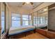 Bedroom featuring mirrored closet doors, a window, and an exit sign at 7750 E Broadway Rd # 361, Mesa, AZ 85208