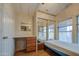 Bedroom featuring mirrored closet doors, a built-in desk, and a window at 7750 E Broadway Rd # 361, Mesa, AZ 85208