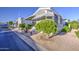 Well-kept mobile home with front porch, stairs, and mature landscaping including trees and desert-style rock at 7750 E Broadway Rd # 361, Mesa, AZ 85208