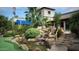 Lush waterfall feature in the landscape, complete with water flowing over rocks, and vibrant greenery at 7750 E Broadway Rd # 361, Mesa, AZ 85208
