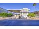 Attractive mobile home featuring a covered carport, front steps, and meticulously maintained landscaping at 7750 E Broadway Rd # 361, Mesa, AZ 85208