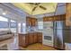Bright kitchen featuring wood cabinets, stainless steel refrigerator, and a seamless flow to the living space at 7750 E Broadway Rd # 361, Mesa, AZ 85208