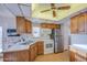 Cozy kitchen featuring wood cabinets, stainless steel refrigerator, and white appliances at 7750 E Broadway Rd # 361, Mesa, AZ 85208