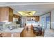 Well-lit kitchen featuring wood cabinets, white appliances, and a cozy breakfast nook at 7750 E Broadway Rd # 361, Mesa, AZ 85208