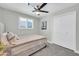 Relaxing bedroom with plush carpeting, ceiling fan, plantation shutters, and a spacious closet at 8 S Cholla St, Gilbert, AZ 85233