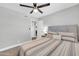 Cozy bedroom with plush carpeting, ceiling fan, and a picture window at 8 S Cholla St, Gilbert, AZ 85233