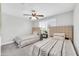 Bright bedroom with plush carpeting, ceiling fan, a window with shutters and two beds at 8 S Cholla St, Gilbert, AZ 85233