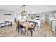 Bright dining room and kitchen feature rustic wood table, island with seating, and wood tile flooring at 8 S Cholla St, Gilbert, AZ 85233