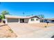 Charming single story exterior with a gravel yard, white painted brick, and attached two car garage at 8 S Cholla St, Gilbert, AZ 85233