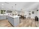 Bright, open kitchen featuring a center island, modern gray cabinetry, and an adjacent dining area at 8 S Cholla St, Gilbert, AZ 85233