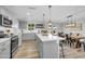 Bright kitchen featuring gray cabinets, a center island, stainless steel appliances, and a dining area at 8 S Cholla St, Gilbert, AZ 85233