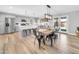 Bright, open concept kitchen and dining room feature wood tile floors and modern stainless appliances at 8 S Cholla St, Gilbert, AZ 85233