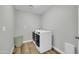 Laundry room with wood-look vinyl floors, gray walls, and a front loading washer and dryer at 8 S Cholla St, Gilbert, AZ 85233