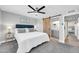 Inviting bedroom with a sliding barn door to the en suite bathroom and a plush carpet at 8 S Cholla St, Gilbert, AZ 85233