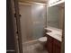 Cozy bathroom featuring a glass-enclosed shower, a vanity with sink, and tiled walls and flooring at 8651 E Royal Palm Rd # 118, Scottsdale, AZ 85258