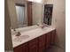 Bathroom with double sink vanity, large mirror, and tiled backsplash at 8651 E Royal Palm Rd # 118, Scottsdale, AZ 85258