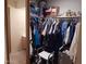 Walk-in closet with clothes hanging, assorted boxes and storage on shelves, offering ample storage space at 8651 E Royal Palm Rd # 118, Scottsdale, AZ 85258