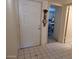 View of the front door with tiled floor and a thermometer hanging on the wall, leading to an interior space at 8651 E Royal Palm Rd # 118, Scottsdale, AZ 85258