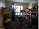 Exercise room with an exercise machine, treadmill, natural light from window with shutters, and storage shelves at 8651 E Royal Palm Rd # 118, Scottsdale, AZ 85258