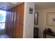 Hallway with wood storage cabinets, decorative mirror, and hanging wall art at 8651 E Royal Palm Rd # 118, Scottsdale, AZ 85258