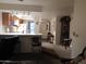 Open floor plan featuring a kitchen with breakfast bar and adjacent living area at 8651 E Royal Palm Rd # 118, Scottsdale, AZ 85258