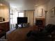 Comfortable living room with fireplace, media center, and view of the outdoor area at 8651 E Royal Palm Rd # 118, Scottsdale, AZ 85258