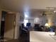 An open-concept living room with a ceiling fan, fireplace, and view of an outdoor patio at 8651 E Royal Palm Rd # 118, Scottsdale, AZ 85258