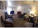 Cozy living room with a brick fireplace, comfortable seating, and neutral carpeting at 8651 E Royal Palm Rd # 118, Scottsdale, AZ 85258