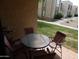 Outdoor patio seating area with a table and chairs surrounded by green space at 8651 E Royal Palm Rd # 118, Scottsdale, AZ 85258