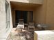 Outdoor patio area with chairs, side table, and desert landscaping at 8651 E Royal Palm Rd # 118, Scottsdale, AZ 85258