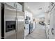 Open kitchen with stainless steel appliances, white cabinets, and a view of the living area at 8716 E Mitchell Dr, Scottsdale, AZ 85251