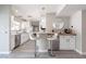 Kitchen featuring a breakfast bar, white cabinetry, stainless steel appliances, and updated fixtures at 8716 E Mitchell Dr, Scottsdale, AZ 85251