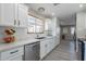 Modern kitchen with white cabinets, marble countertops, and stainless steel appliances at 8716 E Mitchell Dr, Scottsdale, AZ 85251