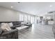 Spacious living room with gray sectional couch, light-colored flooring, and an open concept design at 8716 E Mitchell Dr, Scottsdale, AZ 85251
