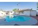 Backyard pool with lounge chairs, covered patio, and privacy fence at 8716 E Mitchell Dr, Scottsdale, AZ 85251