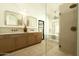Clean, well-lit bathroom with glass shower, soaking tub, and double vanity with modern fixtures at 8910 E Topeka Dr, Scottsdale, AZ 85255