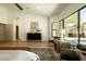 Bright, airy main bedroom with hardwood floors and views of the pool area at 8910 E Topeka Dr, Scottsdale, AZ 85255