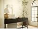 Cozy home office with a modern desk, chair, and a view to the dining room at 8910 E Topeka Dr, Scottsdale, AZ 85255