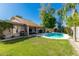 Beautiful backyard with a refreshing pool and lush green grass, perfect for outdoor relaxation at 9203 S Heather Dr, Tempe, AZ 85284