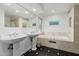 Bright bathroom with a soaking tub, dual sinks, and elegant fixtures at 9203 S Heather Dr, Tempe, AZ 85284