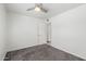 A clean, carpeted bedroom with neutral walls and a ceiling fan for comfort at 9203 S Heather Dr, Tempe, AZ 85284