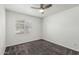 A bright, carpeted bedroom with shuttered window and ceiling fan for comfort at 9203 S Heather Dr, Tempe, AZ 85284