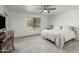 Serene bedroom with a ceiling fan, neutral decor, and a comfortable bed at 9203 S Heather Dr, Tempe, AZ 85284